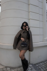 a lady wears a dark brown wool cloak with matching shorts